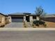 Inviting single-level house with a modern design, desert landscaping, and attached garage at 54 Mirage View Dr, Henderson, NV 89011