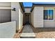 Welcoming front entrance with a stone pathway, modern lighting, and desert landscaping at 54 Mirage View Dr, Henderson, NV 89011