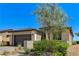A beautiful front exterior of a one-story home featuring desert landscaping, a two-car garage, and modern lighting at 54 Mirage View Dr, Henderson, NV 89011