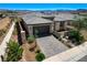 Modern home featuring manicured desert landscaping, a paver driveway, and a desert view at 54 Mirage View Dr, Henderson, NV 89011