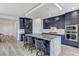 Stylish kitchen with dark blue cabinetry, a large island, and stainless steel appliances at 54 Mirage View Dr, Henderson, NV 89011
