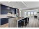 Contemporary kitchen with dark cabinets, quartz countertops, and a central island with seating at 54 Mirage View Dr, Henderson, NV 89011