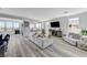 Bright and spacious living room with hardwood flooring, large windows, and modern furnishings, offering ample space for relaxation at 54 Mirage View Dr, Henderson, NV 89011