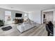 Bright living room with light wood floors, a media center, and views of the outside at 54 Mirage View Dr, Henderson, NV 89011