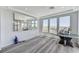 Bright living room with wood floors and views to mountains through three large windows plus a mirrored wall at 54 Mirage View Dr, Henderson, NV 89011