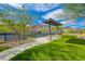 Community park featuring a covered seating area, lush lawn, and a view of the tennis courts at 54 Mirage View Dr, Henderson, NV 89011