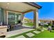 Inviting covered patio with desert views and synthetic grass at 54 Mirage View Dr, Henderson, NV 89011