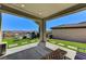 Covered patio with views, green turf and seating at 54 Mirage View Dr, Henderson, NV 89011