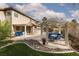 Outdoor patio with a gazebo, blue patio furniture, artificial grass, rock features, and landscaping at 5404 Ireland St, Las Vegas, NV 89149