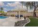 Backyard gazebo with outdoor seating overlooking a beautiful pool and lush landscaping at 5404 Ireland St, Las Vegas, NV 89149