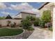 Artificial grass, rock beds, manicured landscaping, and a walkway highlight this backyard at 5404 Ireland St, Las Vegas, NV 89149