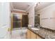 Bathroom with a granite vanity, tub-shower combo, and tile floors at 5404 Ireland St, Las Vegas, NV 89149