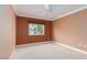 Empty bedroom features plush carpeting, ceiling fan, and large window at 5404 Ireland St, Las Vegas, NV 89149