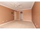 Neutral bedroom featuring carpeted floors, a ceiling fan, and a closet for convenient storage at 5404 Ireland St, Las Vegas, NV 89149