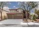 Charming two-story home with a three car garage, tile roof, and beautifully landscaped front yard at 5404 Ireland St, Las Vegas, NV 89149