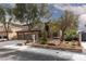 Two-story home featuring stone accents, mature landscaping, and a 3-car garage at 5404 Ireland St, Las Vegas, NV 89149