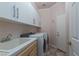 Laundry room with modern appliances, cabinets, and sink at 5404 Ireland St, Las Vegas, NV 89149