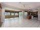 Open-concept living room featuring stone accent wall and seamless kitchen access at 5404 Ireland St, Las Vegas, NV 89149