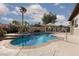 Sparkling blue pool with a jacuzzi, palm trees, and manicured landscaping create a backyard oasis at 5404 Ireland St, Las Vegas, NV 89149