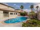 Fenced in pool with a built-in jacuzzi, mature landscaping, and a view of the backyard at 5404 Ireland St, Las Vegas, NV 89149