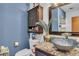 Stylish bathroom featuring a unique vessel sink, modern fixtures, and a decorative mirror at 5424 Neosho St, Las Vegas, NV 89120