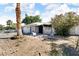 Charming home with desert landscaping, a decorative fence, and mature trees, offering curb appeal and a welcoming entrance at 5424 Neosho St, Las Vegas, NV 89120