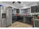 Stylish kitchen with black cabinets, stainless steel appliances, and tile flooring offers a modern and practical cooking space at 5424 Neosho St, Las Vegas, NV 89120
