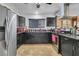 Modern kitchen with sleek black cabinets, stainless steel appliances, and granite countertops, perfect for culinary enthusiasts at 5424 Neosho St, Las Vegas, NV 89120