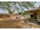 Backyard area with wooden fence and small fish pond at 5600 W Bartlett Ave, Las Vegas, NV 89108