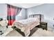 Bedroom with a king bed, small bedside table, and black and red curtains at 5600 W Bartlett Ave, Las Vegas, NV 89108