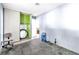 Bedroom area with gray painted walls, mirror, chair and access to another room at 5600 W Bartlett Ave, Las Vegas, NV 89108