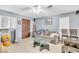 View of the living room with tile floors, ceiling fan, and neutral paint at 5600 W Bartlett Ave, Las Vegas, NV 89108