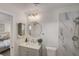 Elegant bathroom with marble tiled shower, sleek vanity, modern fixtures, and bedroom view at 5904 Apple Valley Ln, Las Vegas, NV 89108