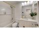 Bright bathroom with white subway tile surround shower-over-tub, modern vanity, and stylish fixtures at 5904 Apple Valley Ln, Las Vegas, NV 89108