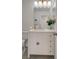 Well-lit bathroom featuring a sleek white vanity with storage, a modern mirror, and neutral finishes at 5904 Apple Valley Ln, Las Vegas, NV 89108