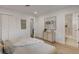 Inviting bedroom featuring wood floors and neutral decor with a glimpse into the bathroom at 5904 Apple Valley Ln, Las Vegas, NV 89108