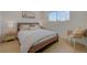 Bedroom with wood floors, modern lamps, decorative pillows, and stylish woven chair at 5904 Apple Valley Ln, Las Vegas, NV 89108