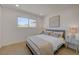 Sunlit bedroom featuring wood flooring, side tables, and a comfortable bed with stylish decor at 5904 Apple Valley Ln, Las Vegas, NV 89108
