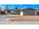 View of single-story home with solar panels, a pink front door, and gravel landscaping at 5904 Apple Valley Ln, Las Vegas, NV 89108