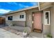 Single-story home featuring a pink front door, modern landscaping, and a 'Welcome' mat at 5904 Apple Valley Ln, Las Vegas, NV 89108