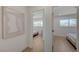 Bright hallway between bedrooms featuring wood floors, white walls, modern decor and an open doorway at 5904 Apple Valley Ln, Las Vegas, NV 89108