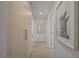Hallway with wood floor, artwork and built-in storage that provides easy access to other areas of the home at 5904 Apple Valley Ln, Las Vegas, NV 89108