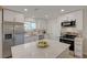 Bright kitchen with stainless steel appliances, white cabinets, quartz countertops, and a kitchen island at 5904 Apple Valley Ln, Las Vegas, NV 89108
