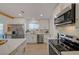 Modern kitchen featuring stainless steel appliances, white cabinets, and a view to the sink at 5904 Apple Valley Ln, Las Vegas, NV 89108