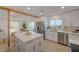 Bright kitchen boasts stainless steel appliances, an island with quartz countertop, and opens to living room at 5904 Apple Valley Ln, Las Vegas, NV 89108
