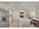 Modern kitchen showcasing white cabinets, stainless steel appliances, and a marble-topped island, open to the dining area at 5904 Apple Valley Ln, Las Vegas, NV 89108