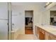 Bathroom boasts dual sink vanity and a shower/tub combo with glass door at 6032 S Pioneer Way, Las Vegas, NV 89113