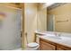 Clean bathroom with a shower, toilet, vanity with sink, and a large mirror at 6032 S Pioneer Way, Las Vegas, NV 89113