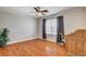 Bedroom with hardwood flooring, neutral walls, ceiling fan, and a desk at 6032 S Pioneer Way, Las Vegas, NV 89113