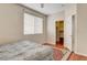 Cozy bedroom with a comfortable bed, laminate flooring, and a closet at 6032 S Pioneer Way, Las Vegas, NV 89113